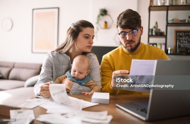 Young family with baby worried about family budget and high taxes 